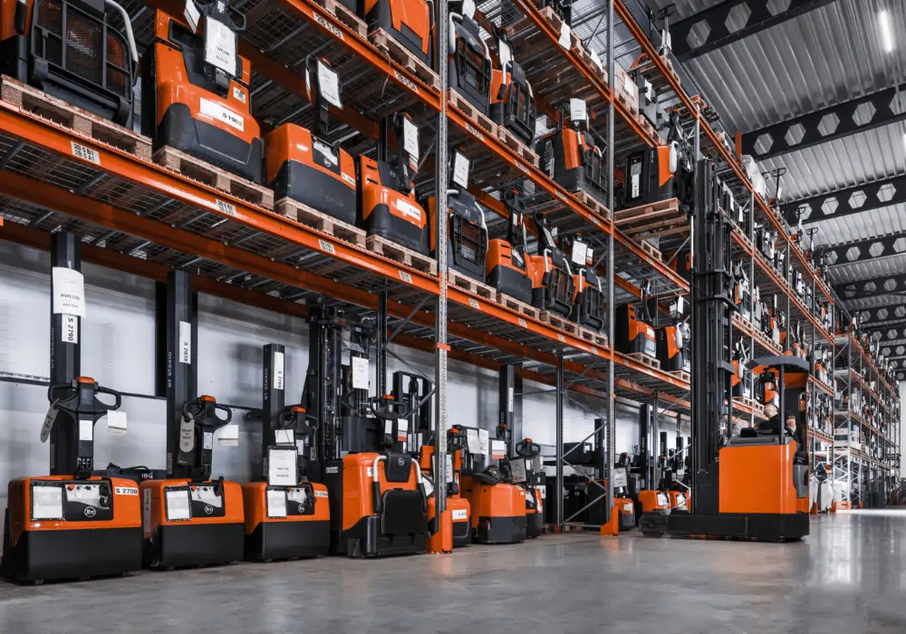 Warehouse with Toyota power pallet trucks and stackers in medium-high racking