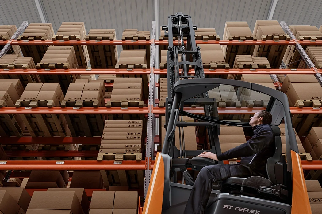 BT Reflex RRE160HE reach truck with tilting cabin. Application photo in warehouse environment.