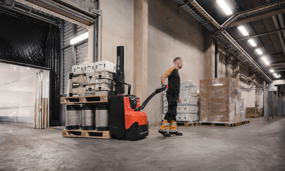 Employee transporting two pallets with Toyota SWE080 powered stacker