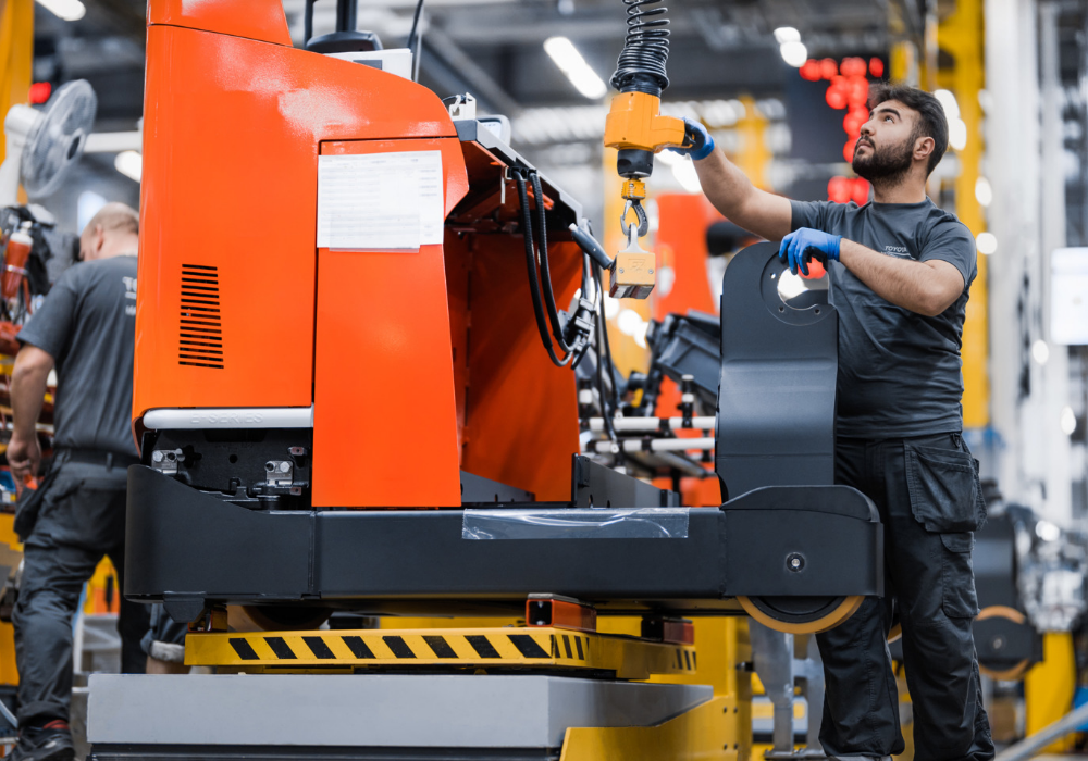 Employee assembling Toyota warehouse truck 